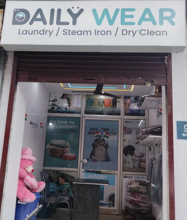 Laundry professional holding suit